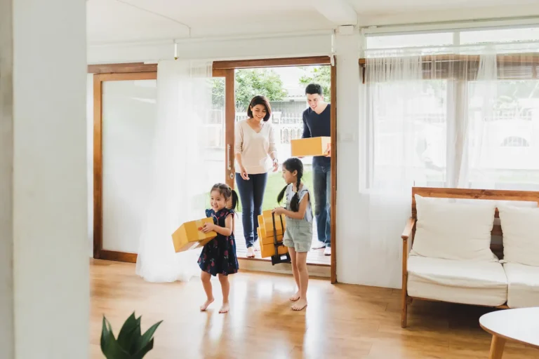 Family moving to new home with packing boxes