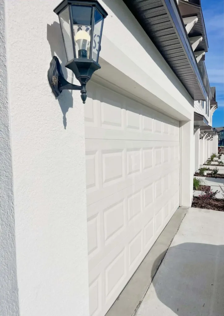 Townhome exterior garage with outdoor lantern-style light
